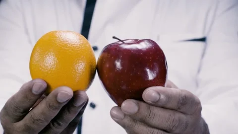 Holding an Apple and Orange Stock Footage 131567014