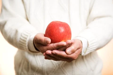 Holding an apple Stock Photos