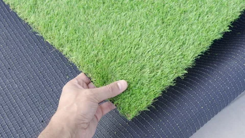Holding an artificial grass roll Stock-Footage 262149580