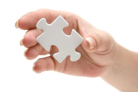 Holding a Blank Puzzle Piece Isolated on a White Background Stock Photos