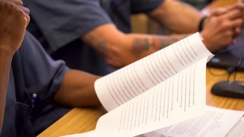 Holding book close up hands white caucasian inmate prisoner jail prison Stock Footage 242650178