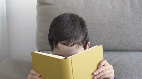 Holding book in front of his face Stock-Footage 253636613