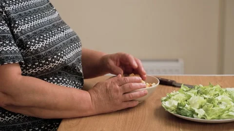 Holding bowl with croutons for preparing Caesar salad. Keeping bread cubes ready Stock Footage 318243092