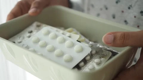 Holding a box of medicine with different types of pills Stock Footage 339994133