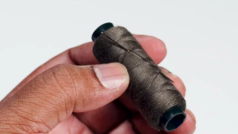 Holding Brown Thread And Needle Stock Footage 248703601