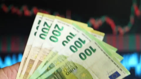 Holding a Bundle of 100 Euro Notes with Background Graphs 스톡 동영상 282744960