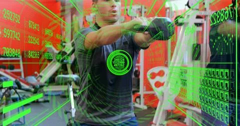 Holding cable handle, man wearing dark shirt wrist-wraps pulling across gym with Stock Photos