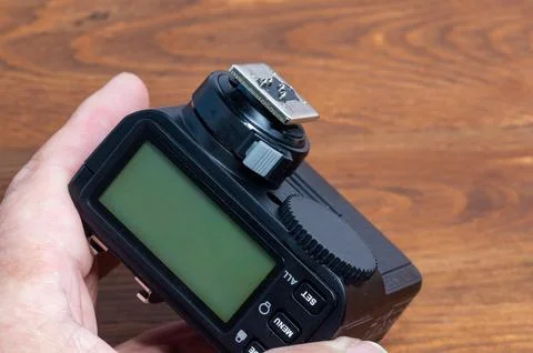 Holding a camera flash trigger in hand. Stock Photos
