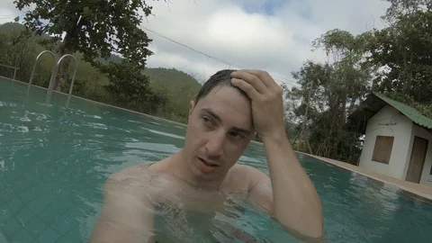 Holding a camera in a swimming pool at Mae Hong Son, Thailand Stock Footage 101241963