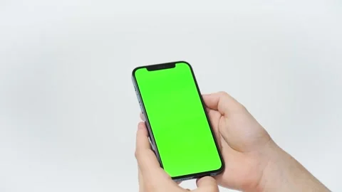 Holding chroma key green screen smartphone watching content with touch Stock Footage 187783958