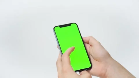 Holding chroma key green screen smartphone watching content with touch Stock Footage 187784194