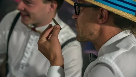 Holding a cigarette only with his thumb and finger Stock Footage 112197264
