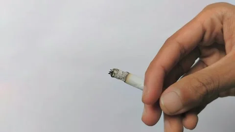 Holding a cigarette on a white background. 스톡 동영상 309979193