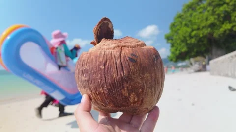 Holding a Coconut Shell While Enjoying Beach Life on Chaweng Beach in Koh Samui Stock Footage 340563339