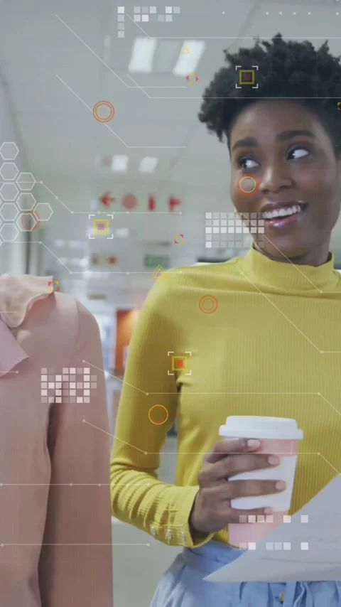 Holding coffee cups and papers, women viewing animation of digital data in Stock Footage 344404131