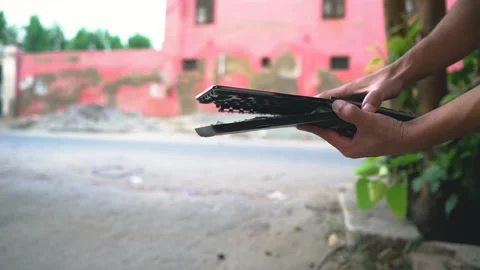 Holding completely broken keyboard - smashed keyboard outdoor morning Stock Footage 138784141