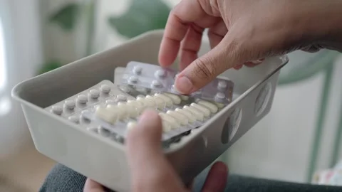 Holding a container with various types of medication Stock Footage 335855315