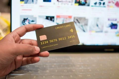 Holding credit card with e-commerce background for business and finance conce Stock-Fotos