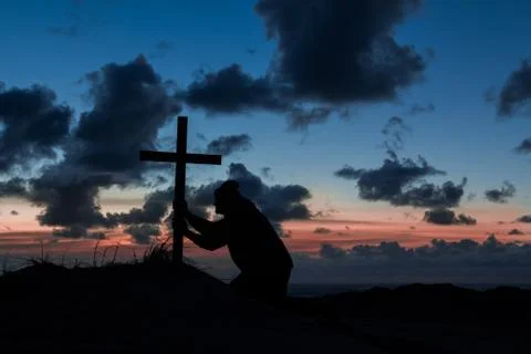 Holding on cross Stock Photos