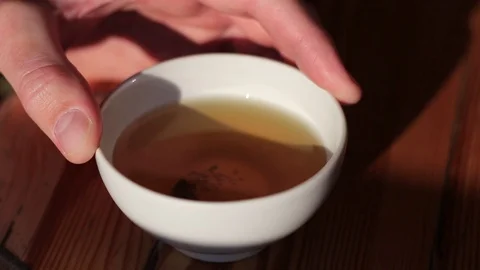 Holding a cup of green tea Stock Footage 70943369