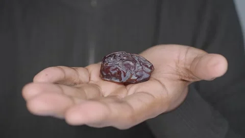 Holding a date fruit in a hand indoors Stock Footage 335119660