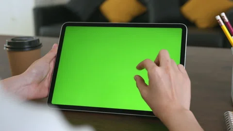 Holding digital tablet with green screen and touch device browsing Internet. 스톡 동영상 135503239