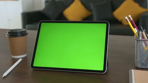 Holding digital tablet with green screen and touch device browsing Internet. 스톡 동영상 135503386