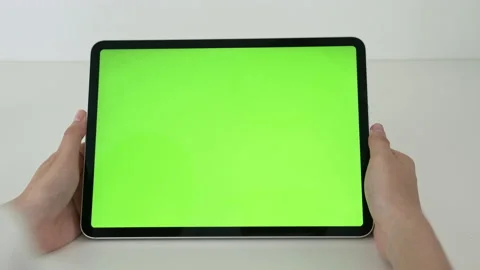 Holding digital tablet with green screen and touch device browsing Internet. 스톡 동영상 135503574