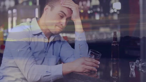 Holding drink at bar, pensive man with sunset animation in background Stock Footage 305835828