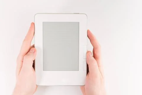 Holding E-book reader in hands. Book with hands isolated on white background Stock Photos