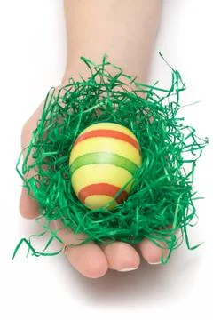 Holding an Easter Egg Isolated on a White Background Фото