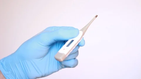 Holding electronic thermometer in gloves Видео 96239964