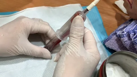 Holding evacuated collection tubes during blood draw Stock Footage 135980554