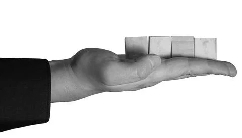 Holding four rectangular blocks on an open palm against a white background Stock Photos