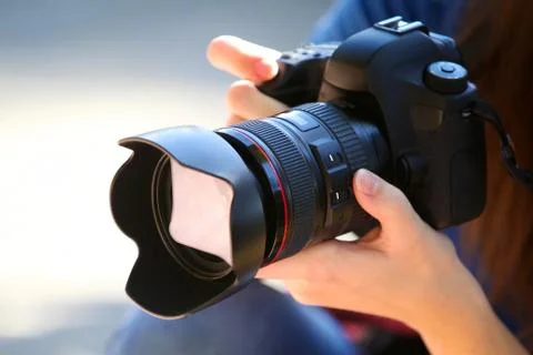 Holding a Full Frame Camera. Stock Photos