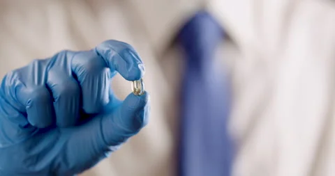 Holding gel pill camera is sliding Video stock 320094380