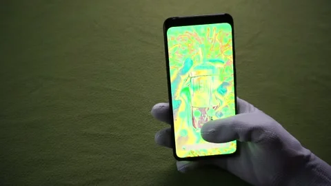 Holding google pixel 4 phone with green screen issues on green background 库存影片 321768871