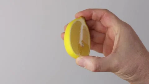 Holding half lemon Stock Footage 323246186