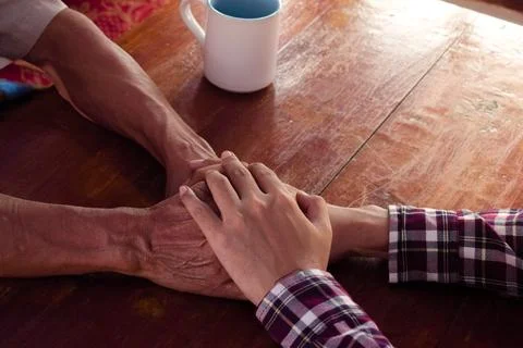 Holding hand between son and father. Mental health, support and sharing, deep Stock Photos