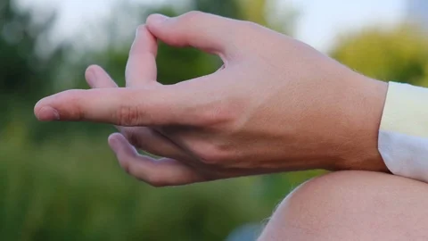Holding hand while meditating on a natural background, close-up Video stock 114759582