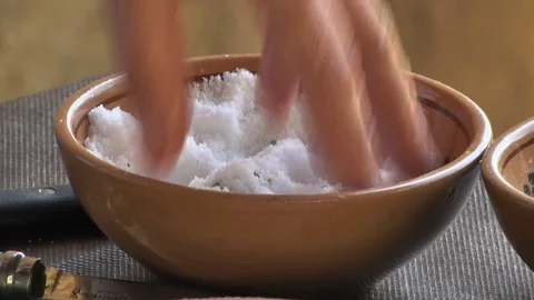 HOLDING A HANDFUL OF SALT Stockbeeldmateriaal 81217021