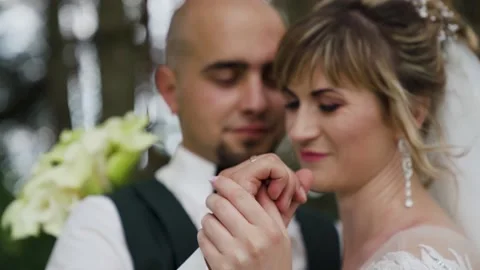 Holding hands against the background of the forest. Couple with kala flowers Stock Footage 221017722