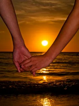 Holding Hands at the Beach Stock Photos