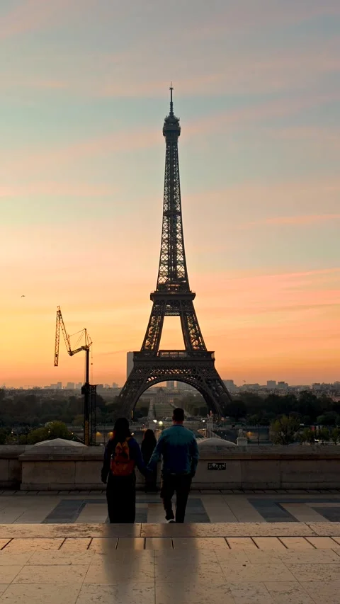 Holding hands at dusk by the Eiffel Tower in Paris, France Video stock 347997728