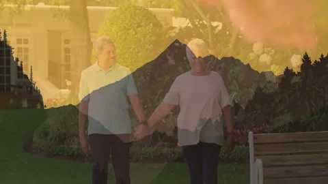 Holding hands, elderly couple with mountain animation overlay in garden Stock Footage 303432210
