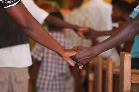 Holding hands at the end of a prayer at a sermon in Namibia Africa Stock Photos
