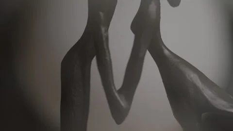 Holding Hands Figurine in a Dark Studio with a Spotlight Video stock 270315330