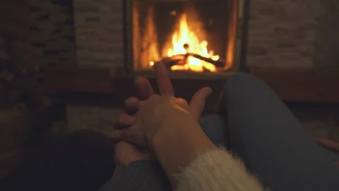 The holding hands on fireplace background Stock-Footage 123150606