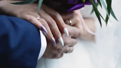 A holding hands together close up of just married couple Stock Footage 124960705