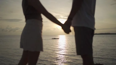 Holding hands while a bangka pass in the middle HLG Slow Motion Stock Footage 246771896